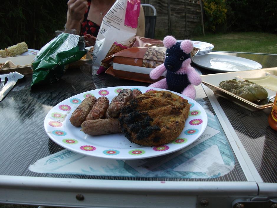 Sheila Bear with a plate of sausages and burgers