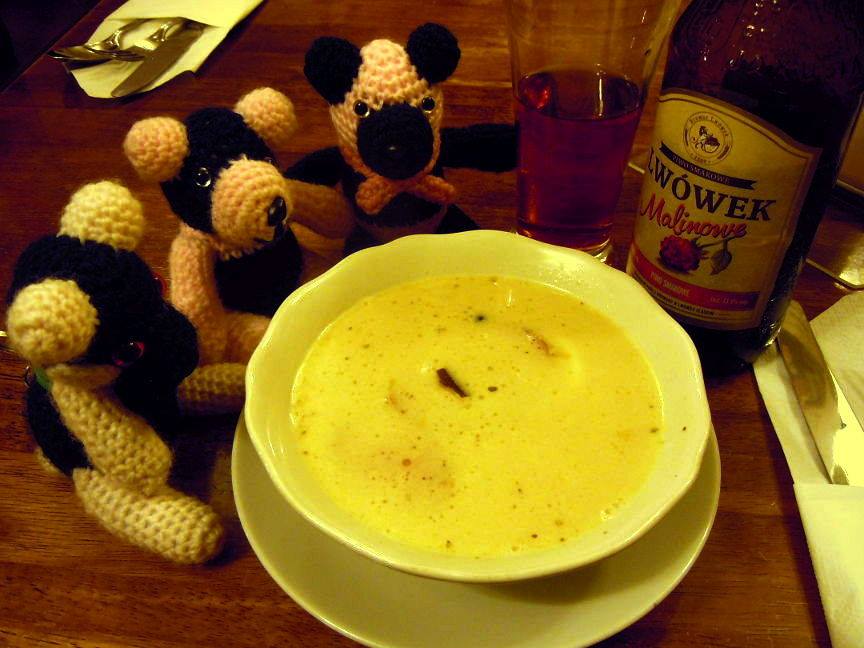 Pandas around a bowl of soup