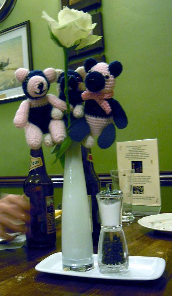 Three pandas on a flower vase
