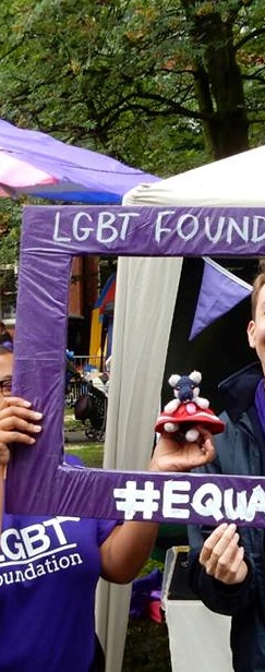 Katie and an LGBT Foundation banner