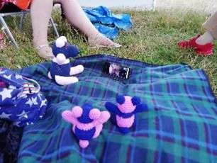 Pandas on a blanket with a phone